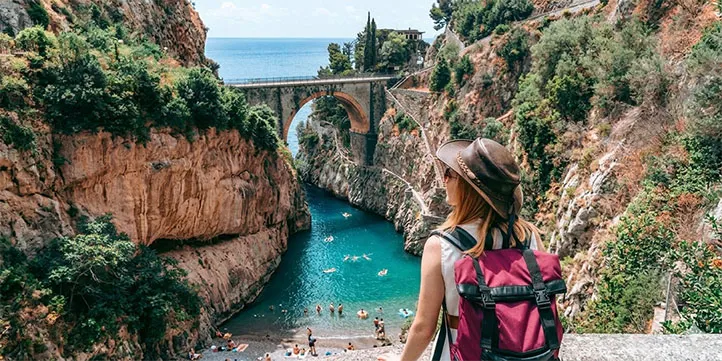 Tourist enjoying the stunning view of Fiordo di Furore during a private sightseeing tour with Taxi Maiori.